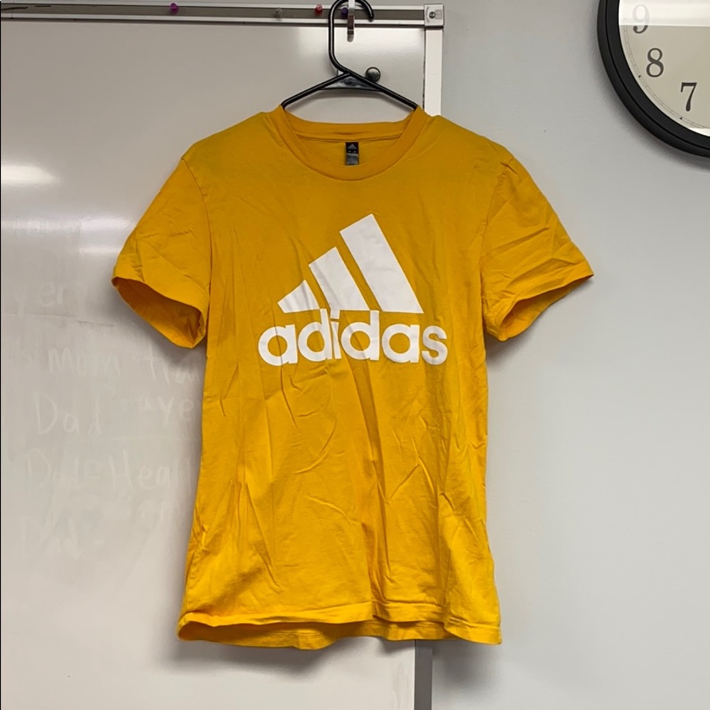 Yellow adidas shirt.